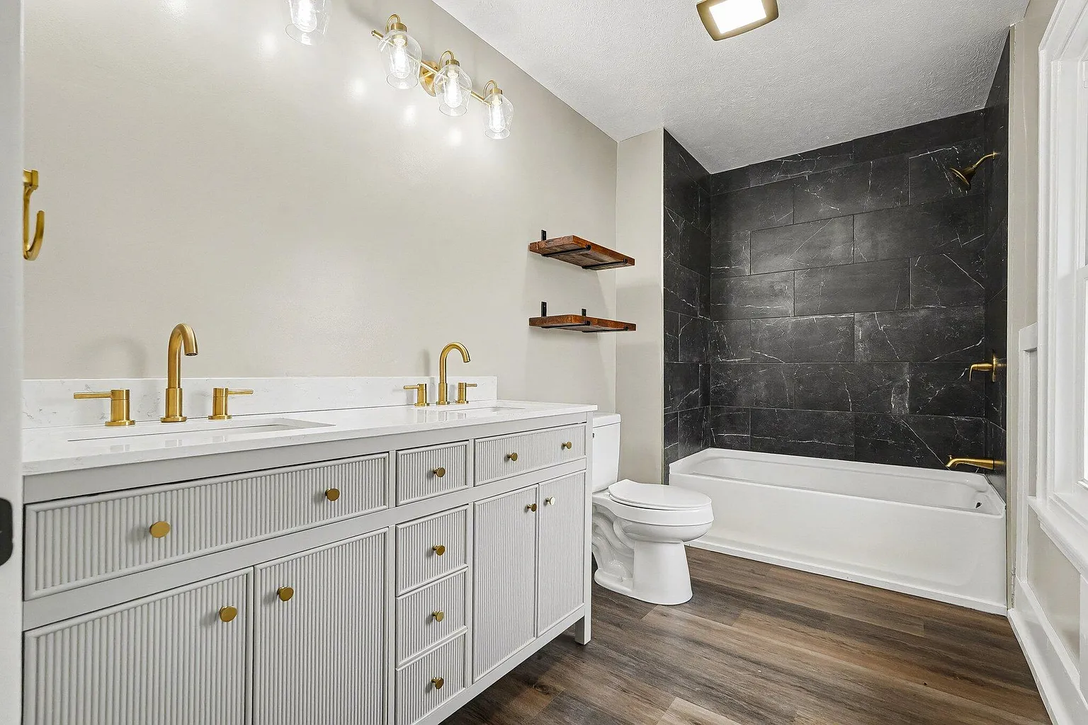 Primary bath with double vanity and tiled tub surround